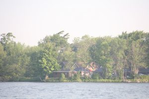 Quaint cottages surrounded by lush greenery on the shores of Rice Lake, Ontario.