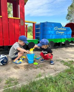 Kids playing in sand at the playground.