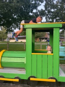 Children playing on wooden playground.